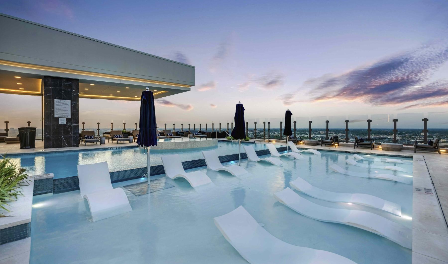 a large pool with chairs around it